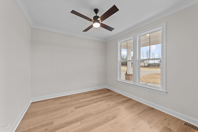 spare room with ceiling fan, ornamental molding, and light hardwood / wood-style floors