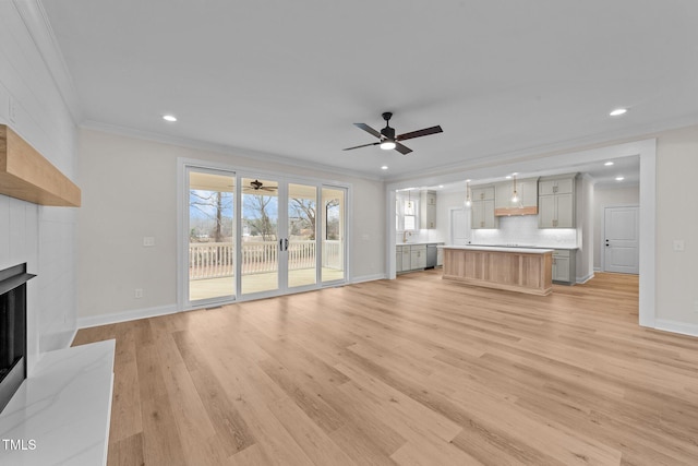 unfurnished living room with ornamental molding, sink, ceiling fan, and light hardwood / wood-style floors