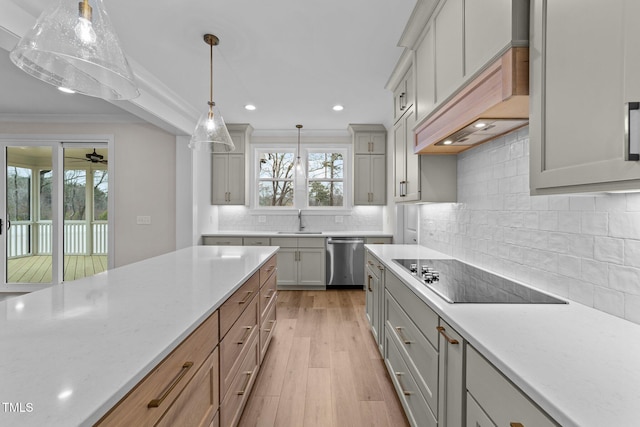 kitchen featuring premium range hood, decorative light fixtures, dishwasher, sink, and black electric cooktop