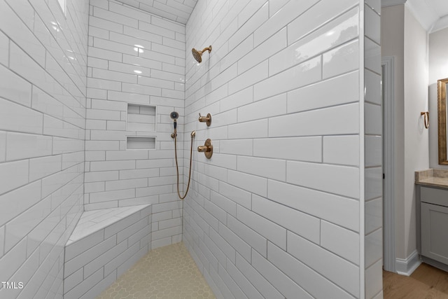 bathroom with vanity and tiled shower