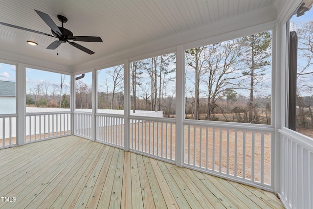 unfurnished sunroom with ceiling fan