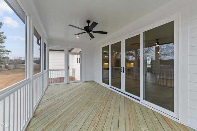 unfurnished sunroom featuring a wealth of natural light and ceiling fan