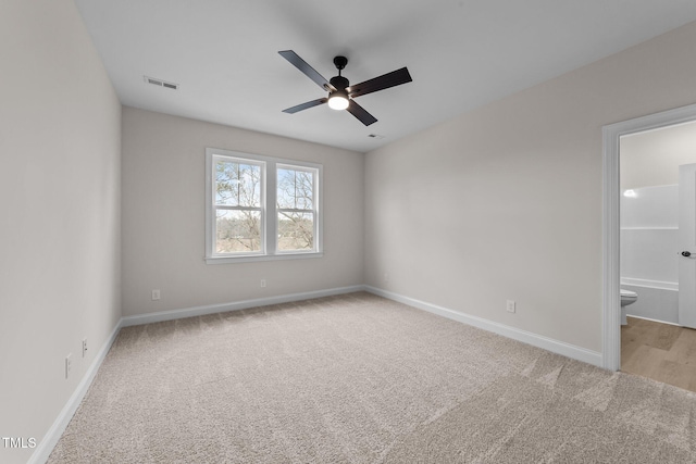 unfurnished room with light colored carpet and ceiling fan