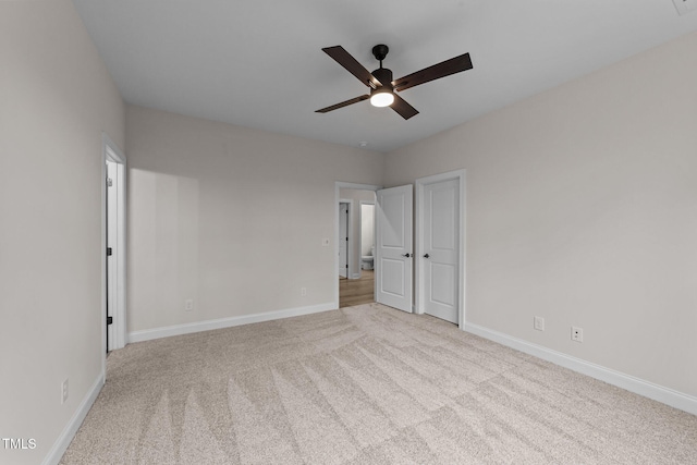 unfurnished bedroom with ceiling fan and light colored carpet