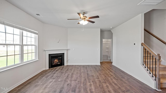 unfurnished living room featuring wood-type flooring and ceiling fan