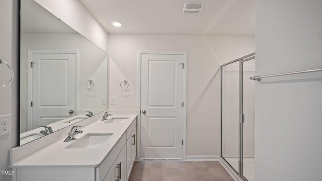 bathroom featuring vanity and an enclosed shower