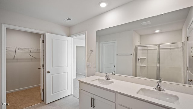 bathroom with vanity and a shower with shower door