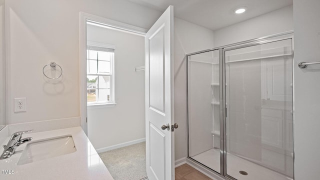 bathroom with vanity and a shower with shower door