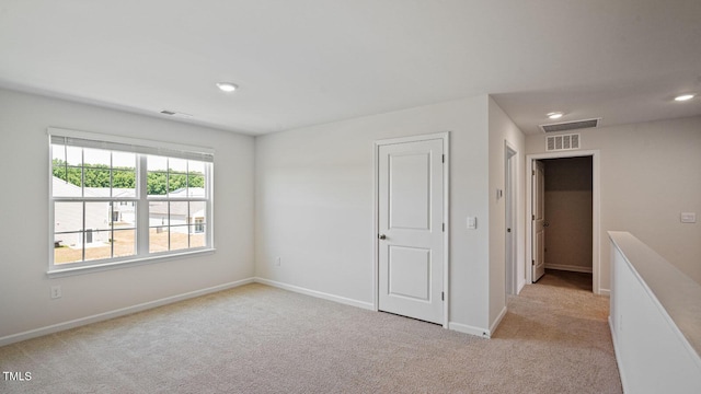 spare room with light colored carpet