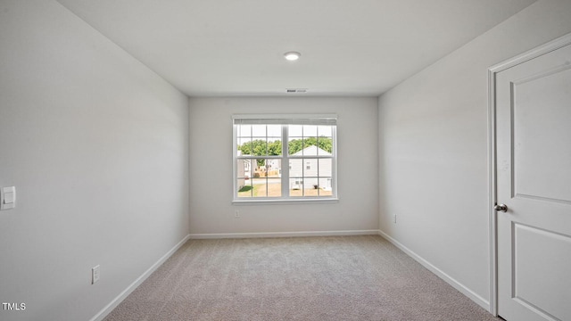 spare room with light colored carpet