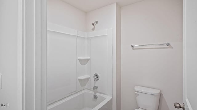 bathroom featuring bathing tub / shower combination and toilet