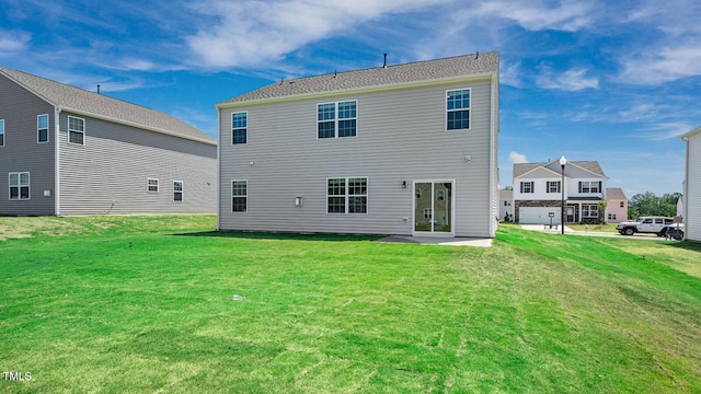 back of house featuring a yard and a patio