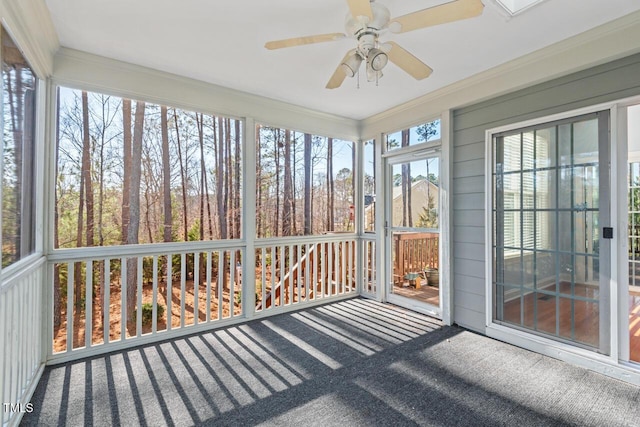 unfurnished sunroom featuring ceiling fan