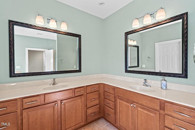 bathroom featuring double vanity, a sink, and tile patterned floors