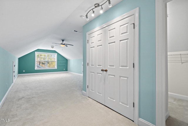 bonus room featuring lofted ceiling, carpet, visible vents, and baseboards