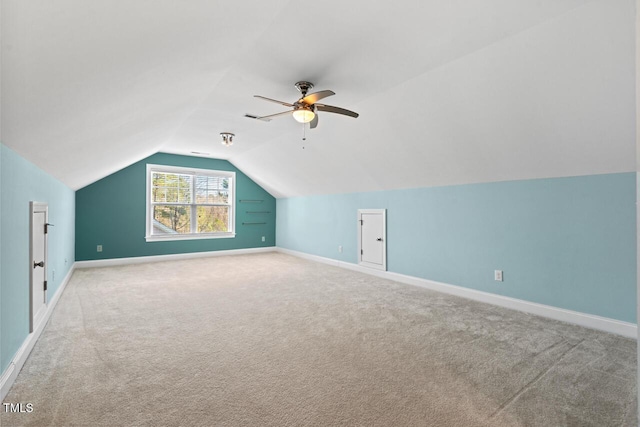 additional living space with lofted ceiling, carpet flooring, and baseboards