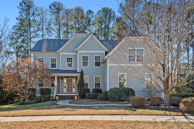 view of front of property with a porch and a shingled roof