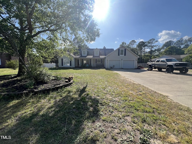 view of front of property with a front yard and a garage