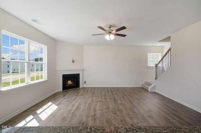 unfurnished living room featuring hardwood / wood-style flooring and ceiling fan