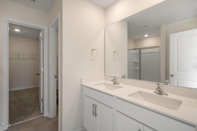 bathroom featuring vanity and a shower with shower door