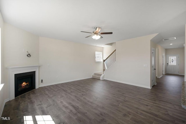 unfurnished living room with dark wood-type flooring and ceiling fan