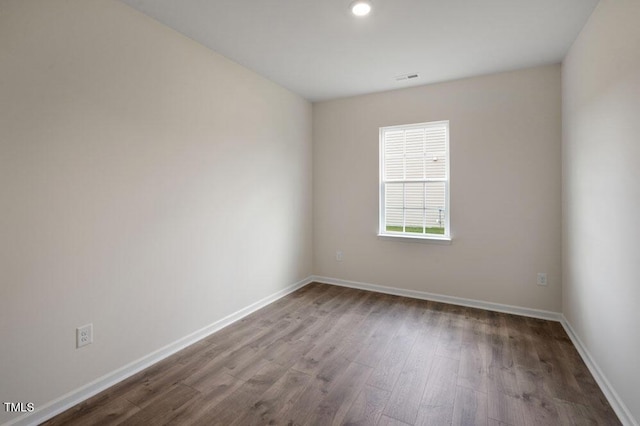 unfurnished room featuring hardwood / wood-style flooring