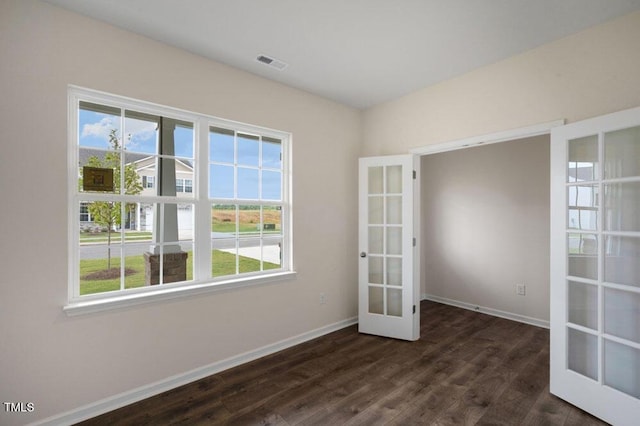 unfurnished room featuring french doors and dark hardwood / wood-style floors