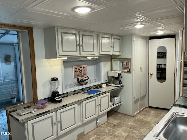 kitchen with white cabinetry and sink