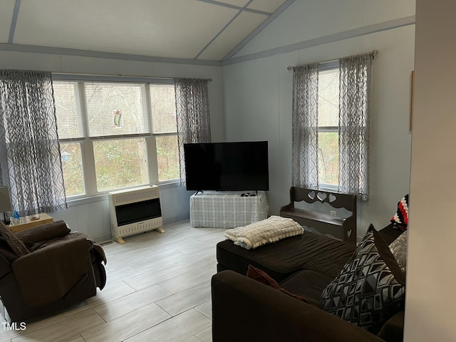 living room featuring lofted ceiling and heating unit