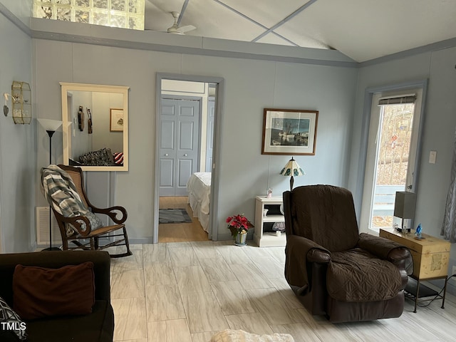 sitting room featuring plenty of natural light, ceiling fan, and vaulted ceiling