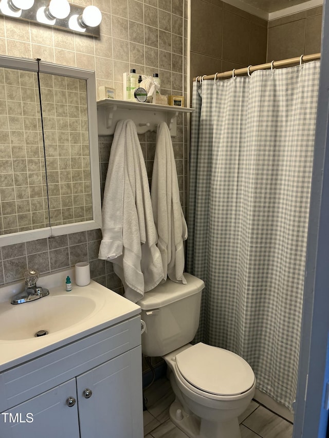 bathroom featuring toilet, tasteful backsplash, tile walls, vanity, and a shower with shower curtain