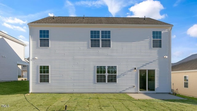 rear view of house with a lawn and a patio area