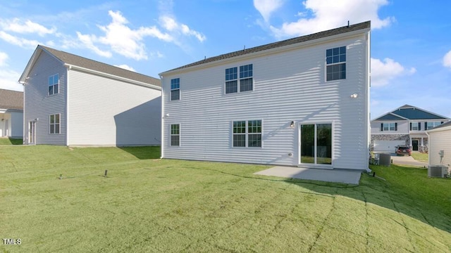 rear view of house with a yard and a patio