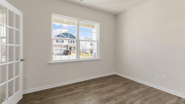 spare room featuring dark hardwood / wood-style flooring