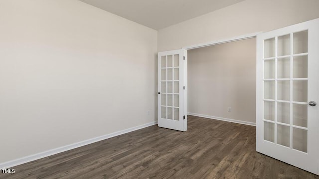 unfurnished room featuring dark hardwood / wood-style flooring and french doors