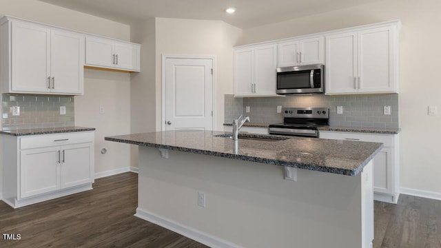 kitchen with white cabinetry, an island with sink, appliances with stainless steel finishes, and sink