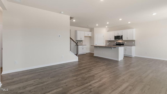 unfurnished living room featuring wood-type flooring