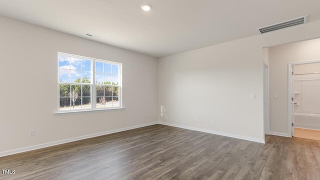 empty room featuring dark hardwood / wood-style flooring