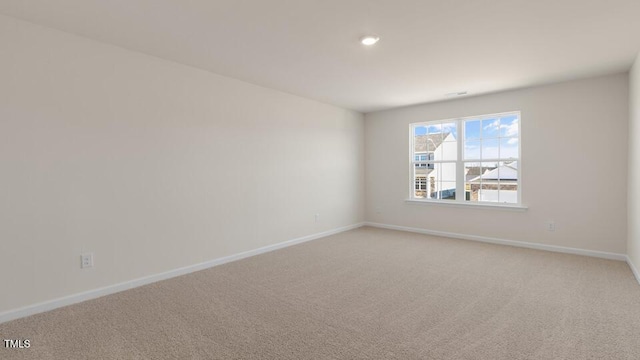 unfurnished room featuring carpet