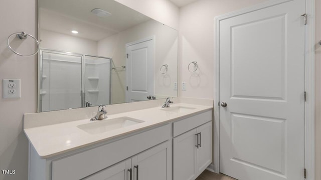 bathroom with vanity and a shower with shower door