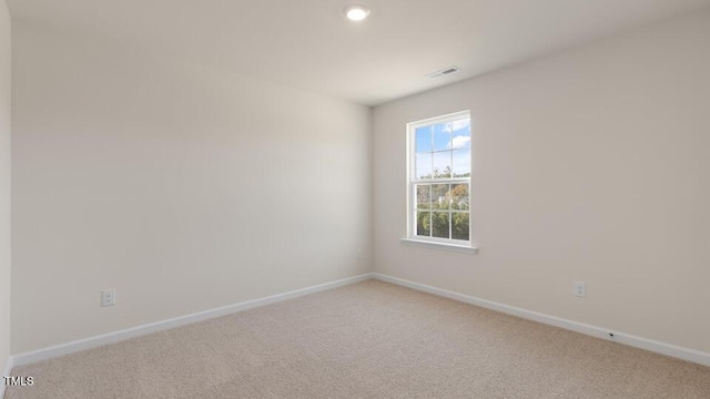 empty room featuring light carpet