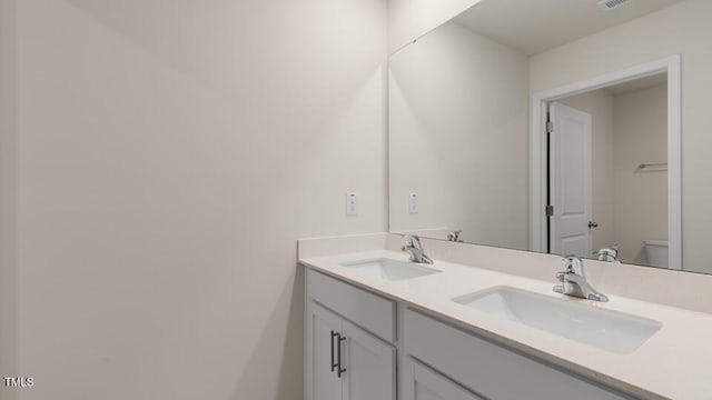 bathroom with vanity and toilet