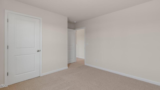 unfurnished bedroom with light colored carpet