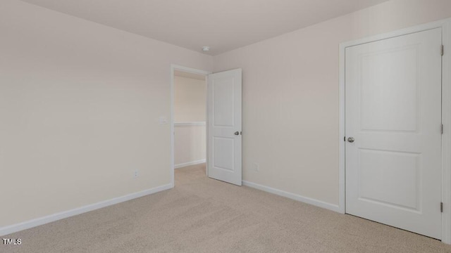 unfurnished bedroom featuring light carpet