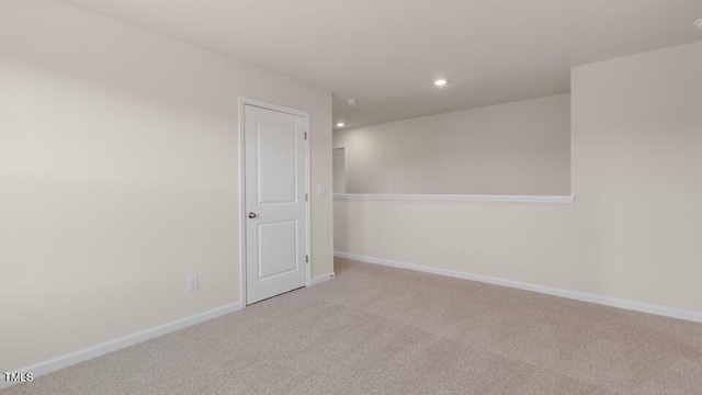 spare room featuring light colored carpet