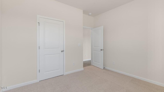 unfurnished bedroom with light colored carpet