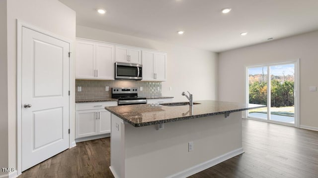 kitchen featuring sink, appliances with stainless steel finishes, white cabinetry, an island with sink, and dark hardwood / wood-style flooring