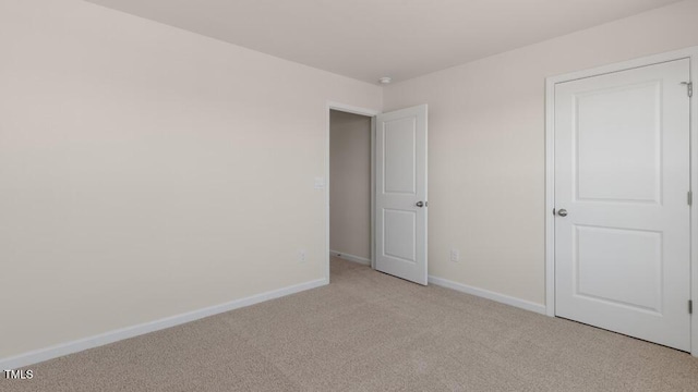 unfurnished bedroom featuring light carpet