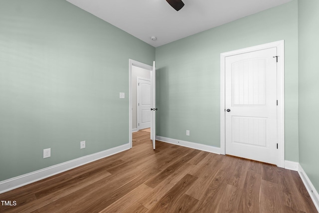 unfurnished bedroom with baseboards, a ceiling fan, and wood finished floors