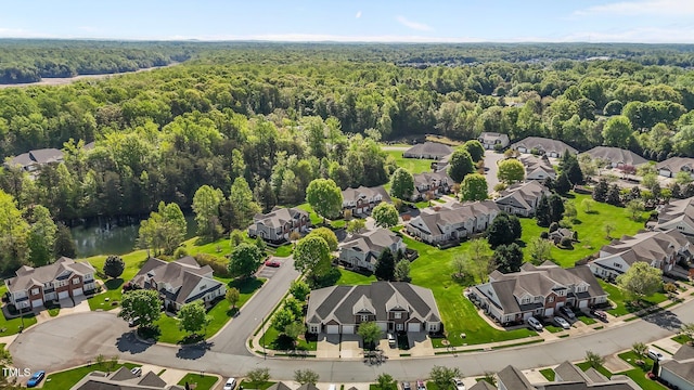 birds eye view of property featuring a residential view, a wooded view, and a water view